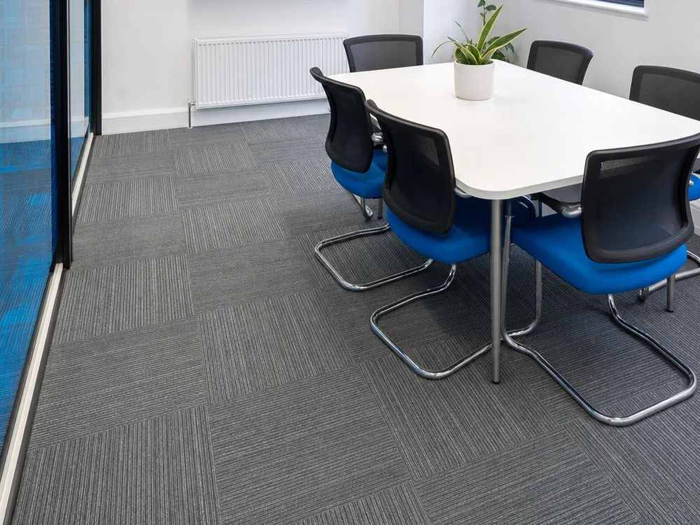 Cleaned carpet tiles in a Leeds office meeting room with an even finish